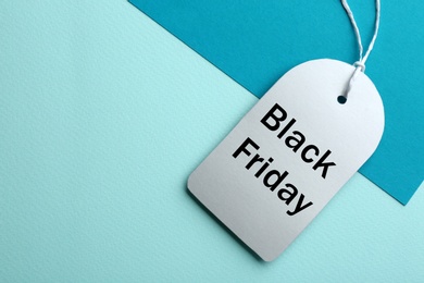 Top view of blank tag on color background, space for text. Black Friday concept