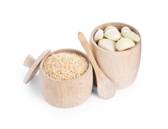 Dehydrated garlic granules, peeled cloves and spoon isolated on white