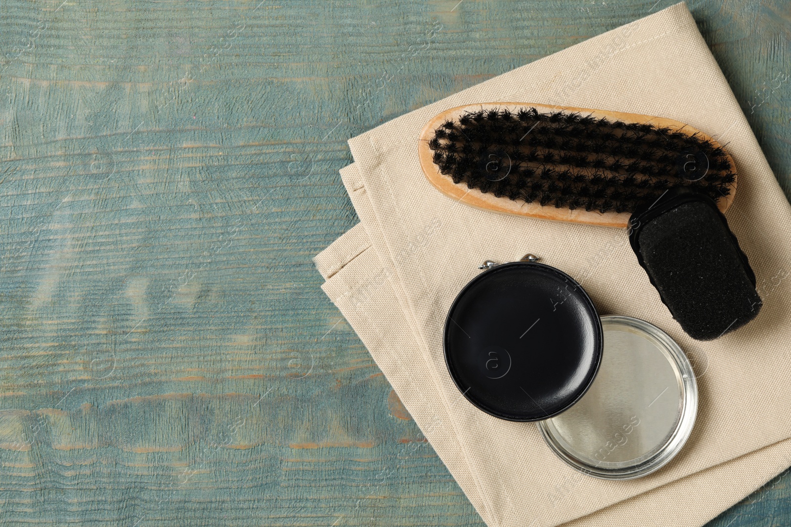 Photo of Shoe care accessories on wooden background, top view. Space for text