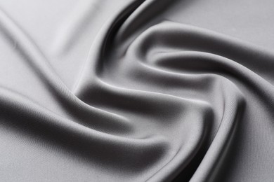 Texture of beautiful light grey silk fabric as background, closeup