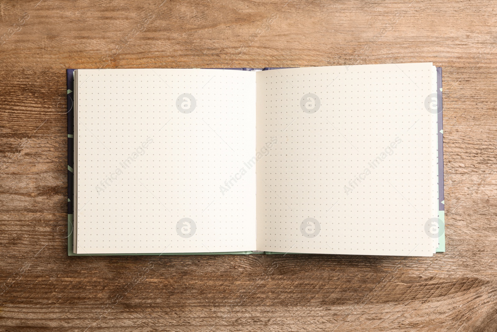 Photo of Stylish open notebook on wooden table, top view. Space for design