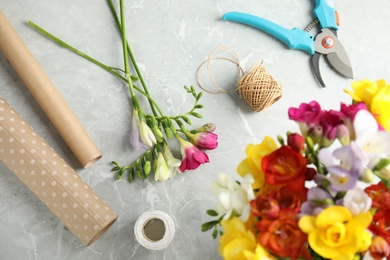 Photo of Flat lay composition with freesia flowers on table