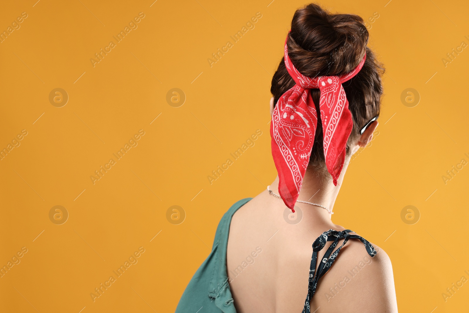 Photo of Woman with stylish bandana on yellow background. Space for text