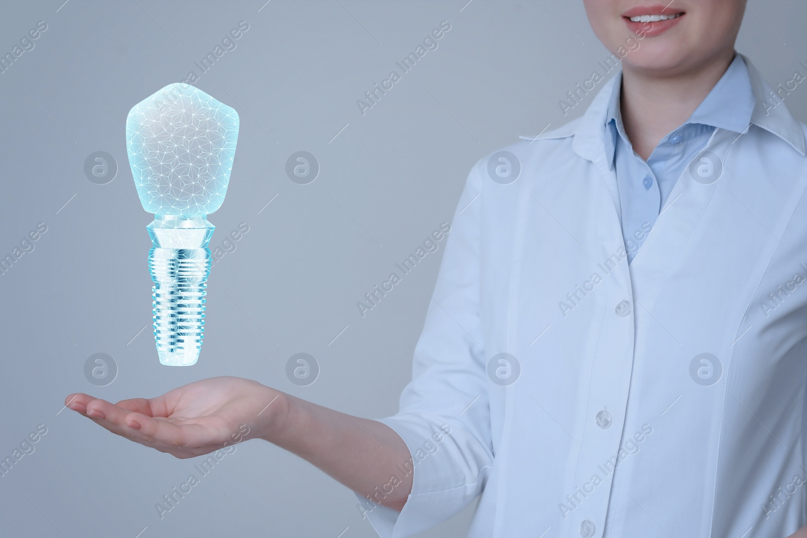 Image of Doctor demonstrating virtual image of dental implant on light background, closeup