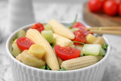 Tasty baby corn with vegetables and champignons on table, closeup