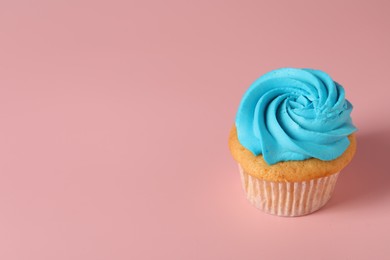 Photo of Delicious cupcake with bright cream on pink background, space for text