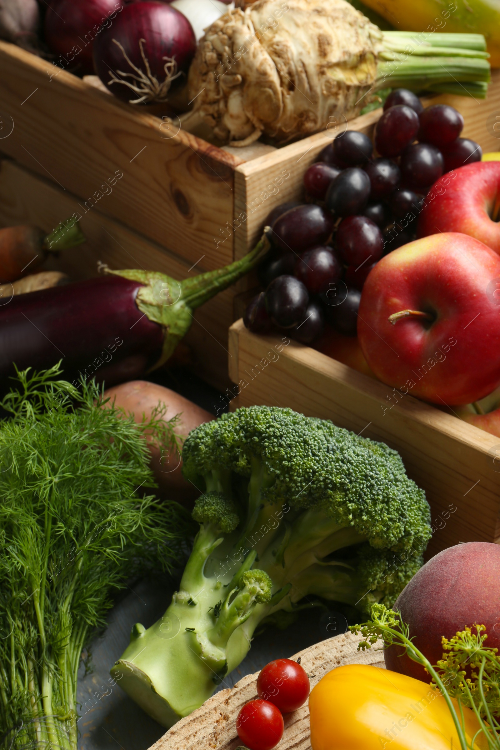 Photo of Different fresh vegetables and fruits on grey wooden table, closeup. Farmer harvesting