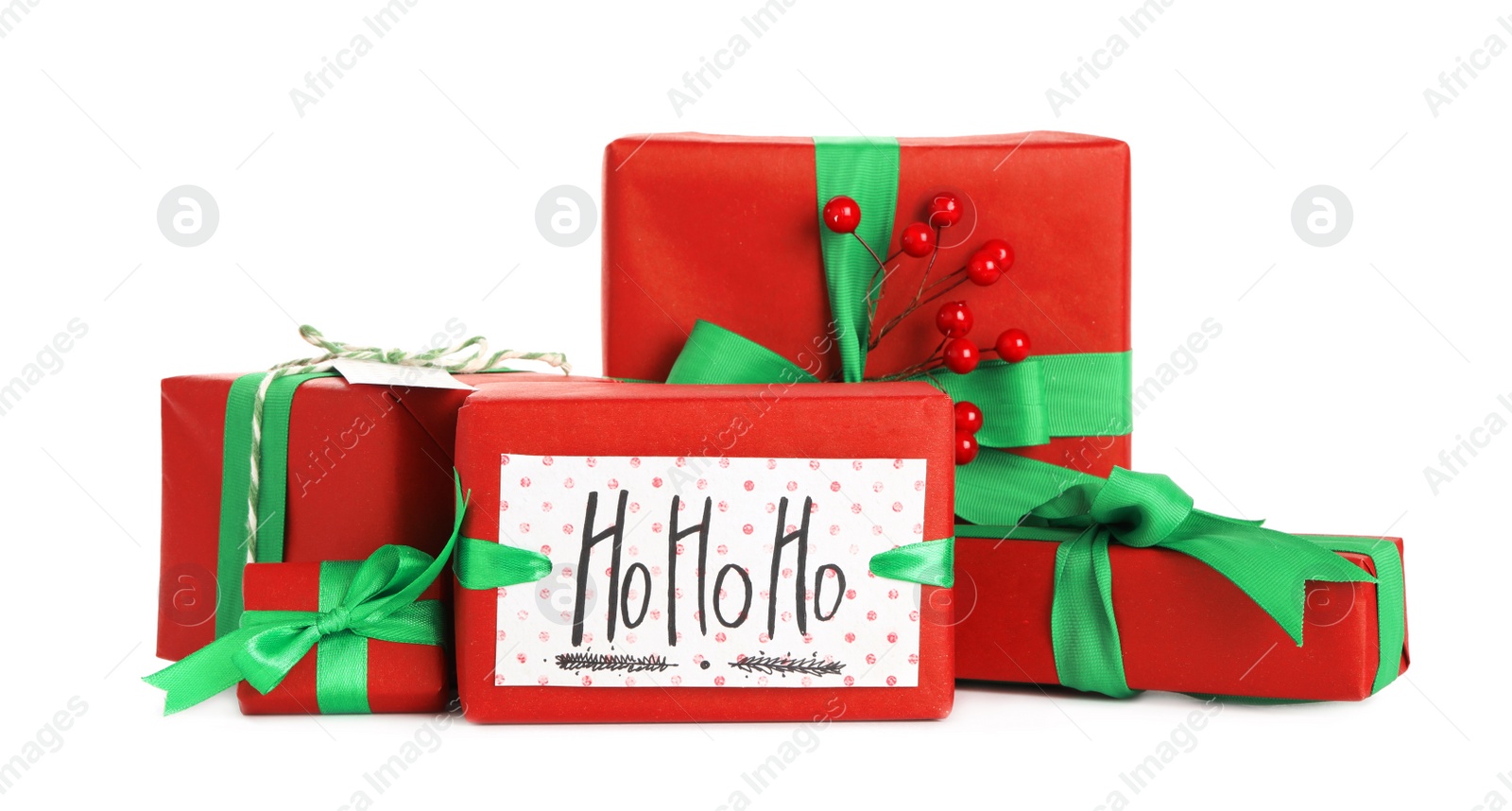 Photo of Christmas gifts with red berries on white background