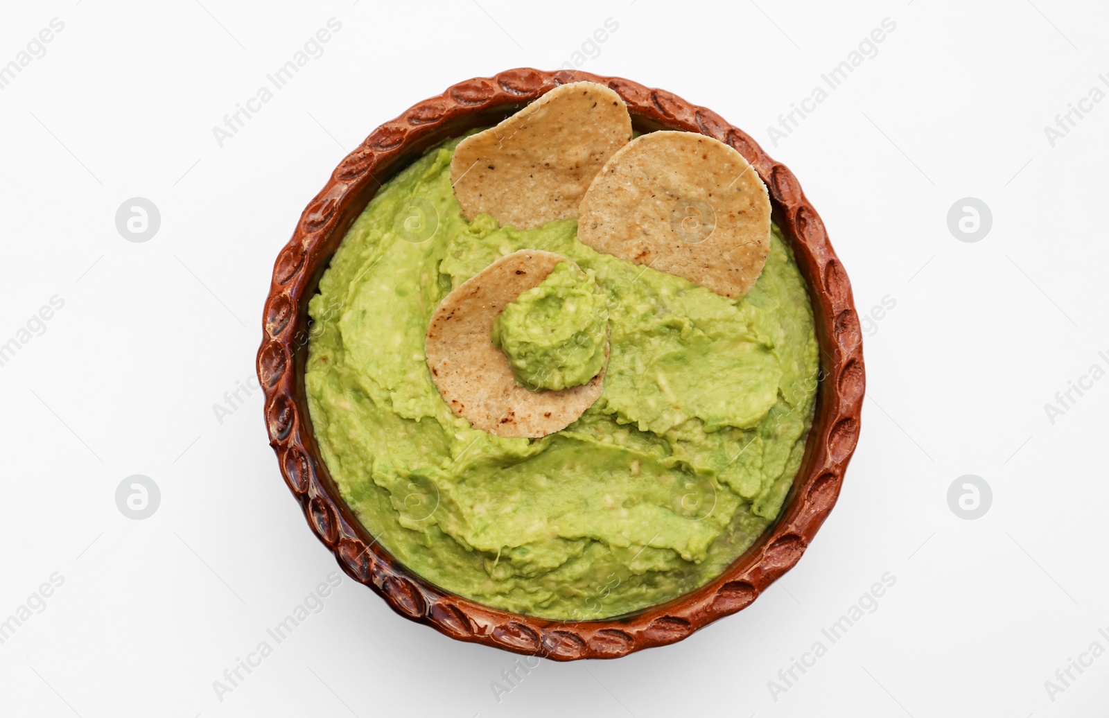 Photo of Delicious guacamole made of avocados with chips on white background, top view