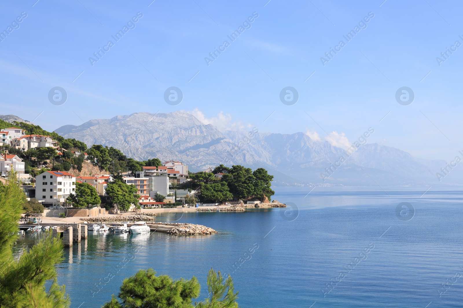 Photo of Beautiful seascape with mountains under blue sky outdoors