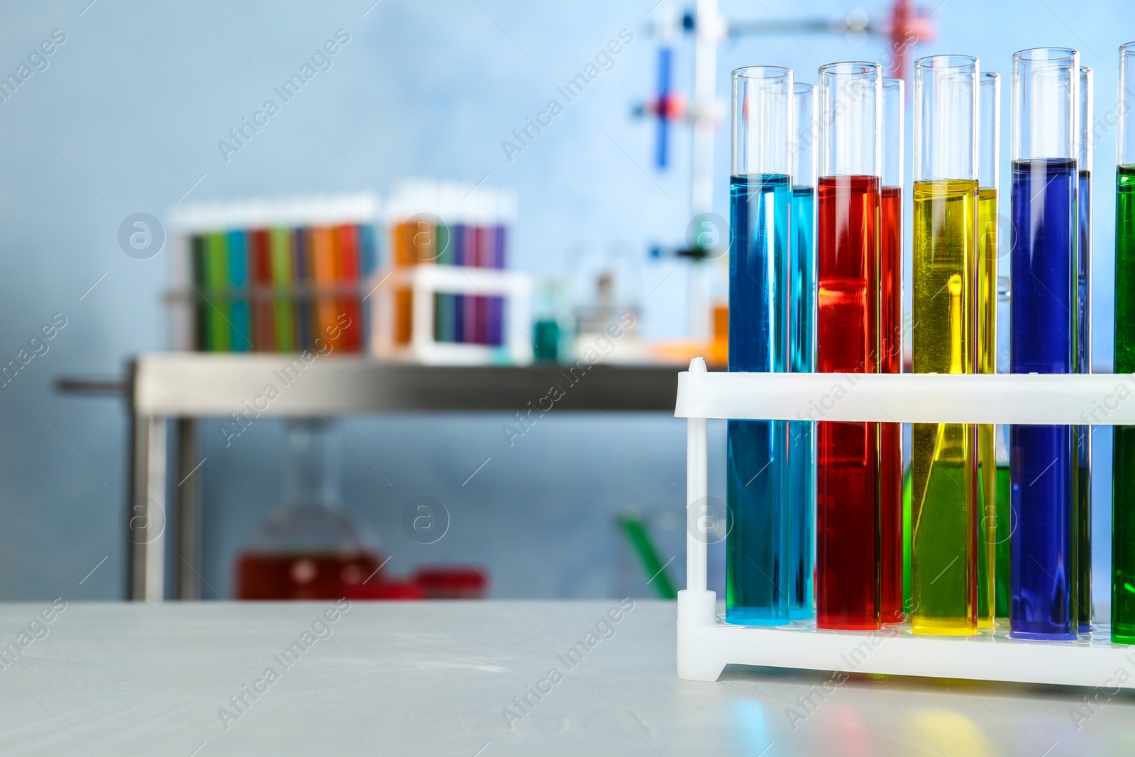 Photo of Test tubes with samples on table in chemistry laboratory. Space for text