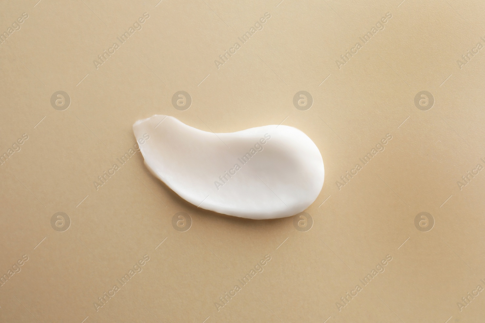 Photo of Sample facial cream on beige background, top view