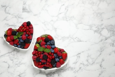 Photo of Mix of ripe berries on white marble table, flat lay. Space for text