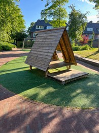 Photo of Wooden playhouse for kids on sunny day