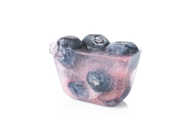 Photo of Ice cube with blueberries on white background