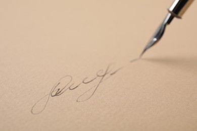 Signing on sheet of paper with fountain pen, closeup. Space for text