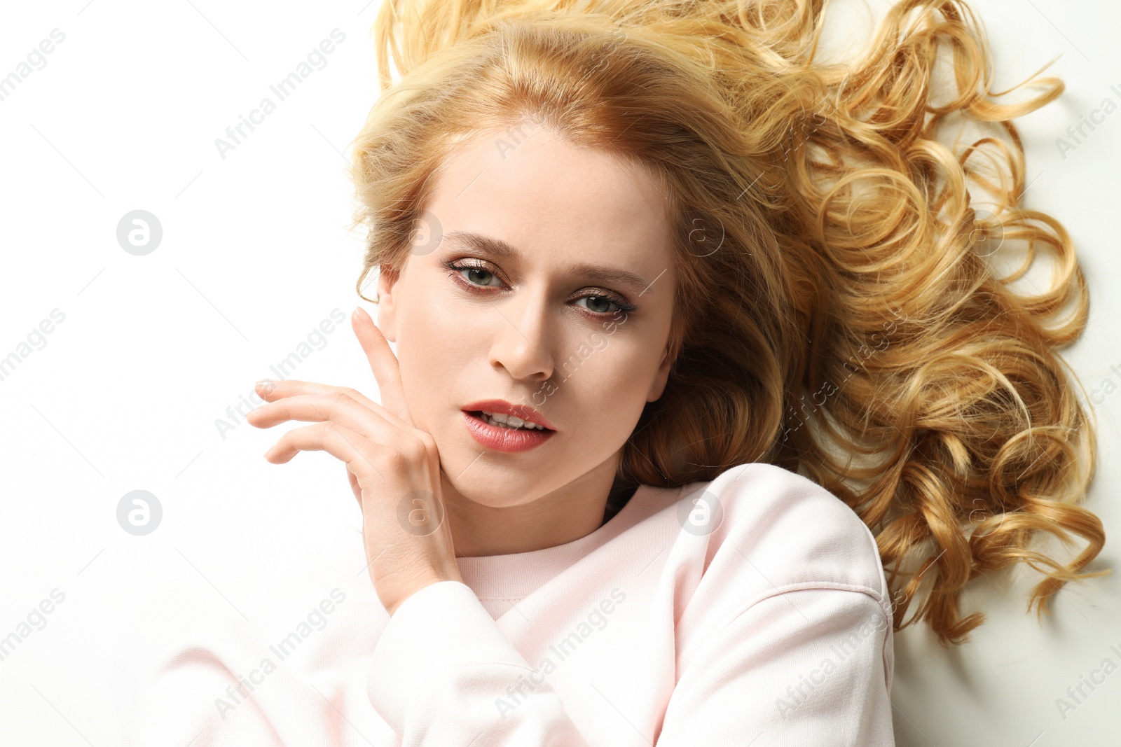 Photo of Portrait of beautiful young woman with dyed long hair on white background, top view