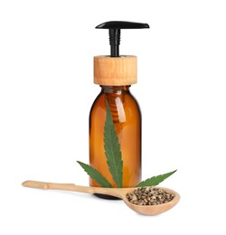 Photo of Bottle of hemp cosmetics with green leaf and seeds isolated on white