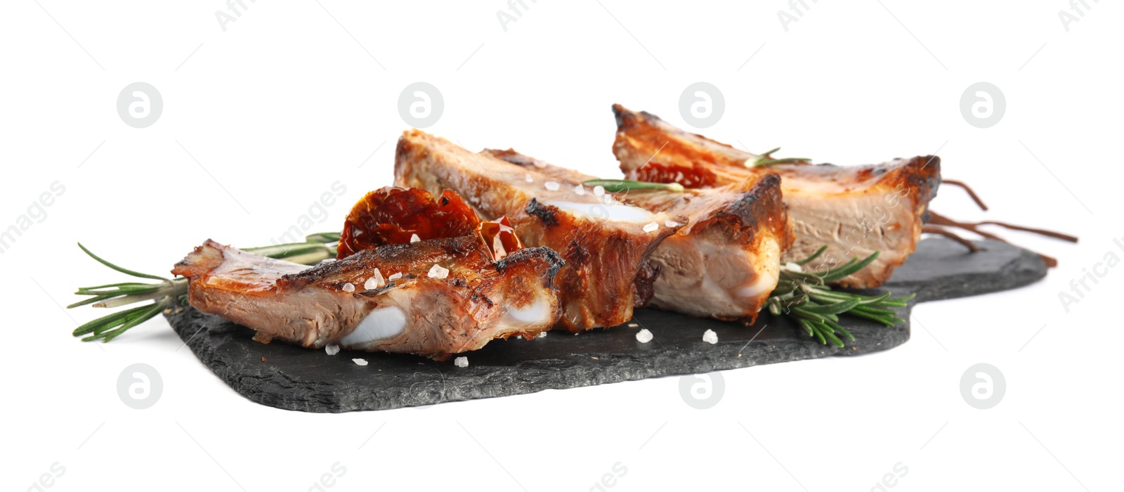 Photo of Slate plate with tasty grilled ribs isolated on white