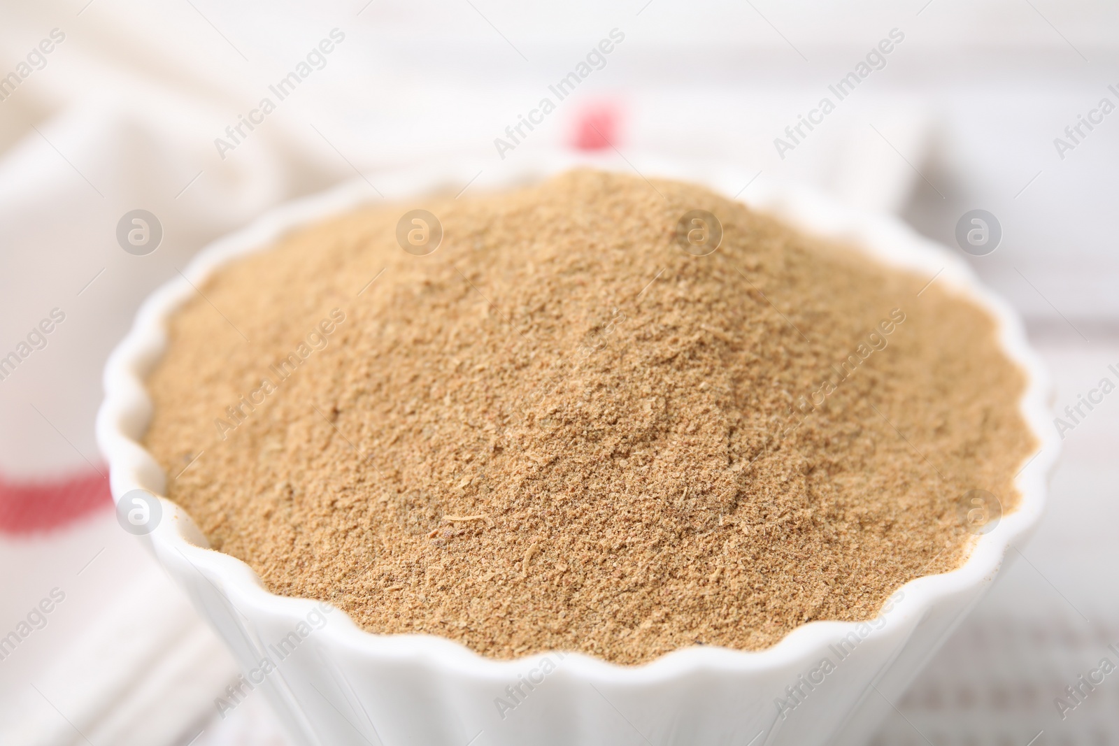 Photo of Dietary fiber. Psyllium husk powder in bowl on table, closeup