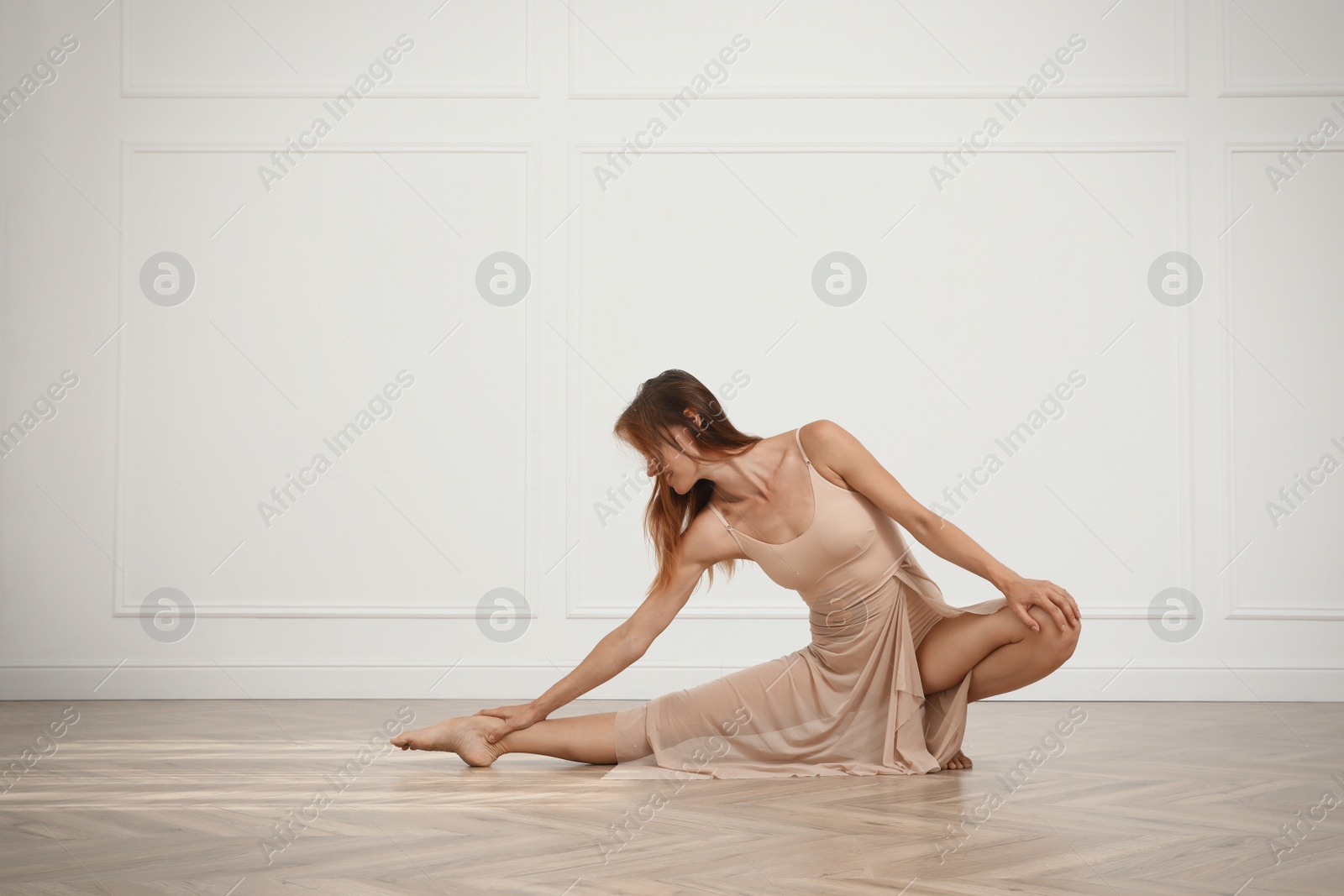 Photo of Beautiful professional dancer practicing moves in studio