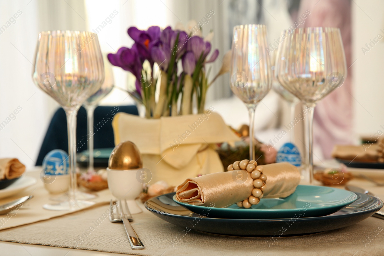 Photo of Festive Easter table setting with decorated eggs in kitchen