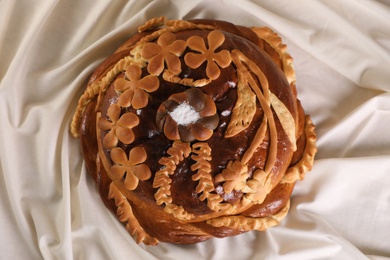 Photo of Korovai on tablecloth, top view. Ukrainian bread and salt welcoming tradition