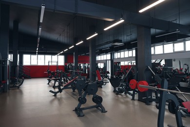 Spacious gym with professional equipment and mirrors
