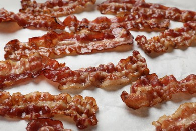 Photo of Slices of tasty fried bacon on white table