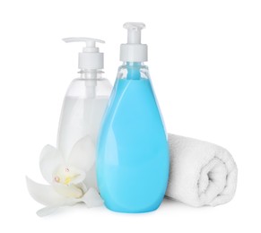 Dispensers of liquid soap, rolled towel and orchid flower on white background