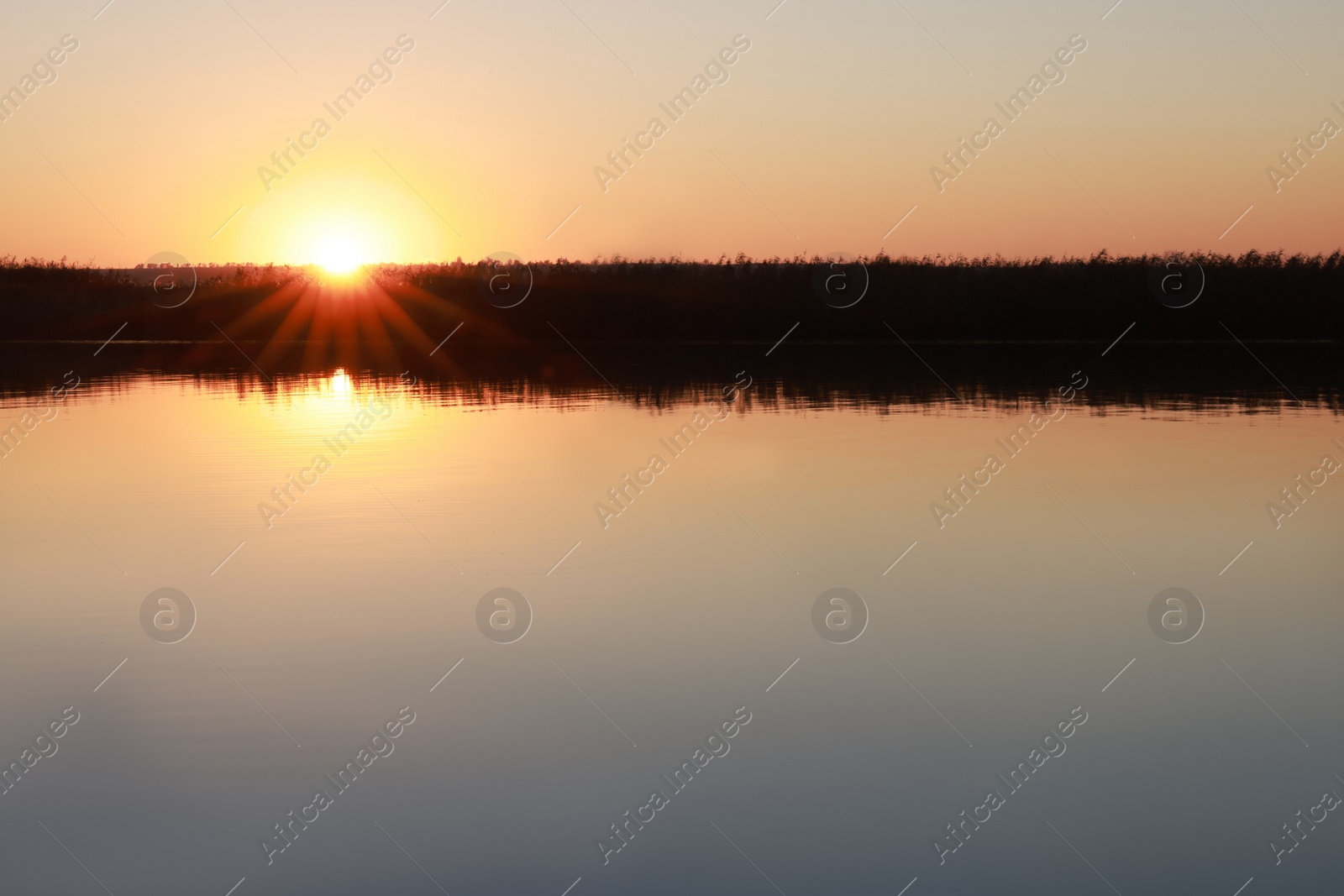 Photo of Picturesque view of tranquil river at sunset