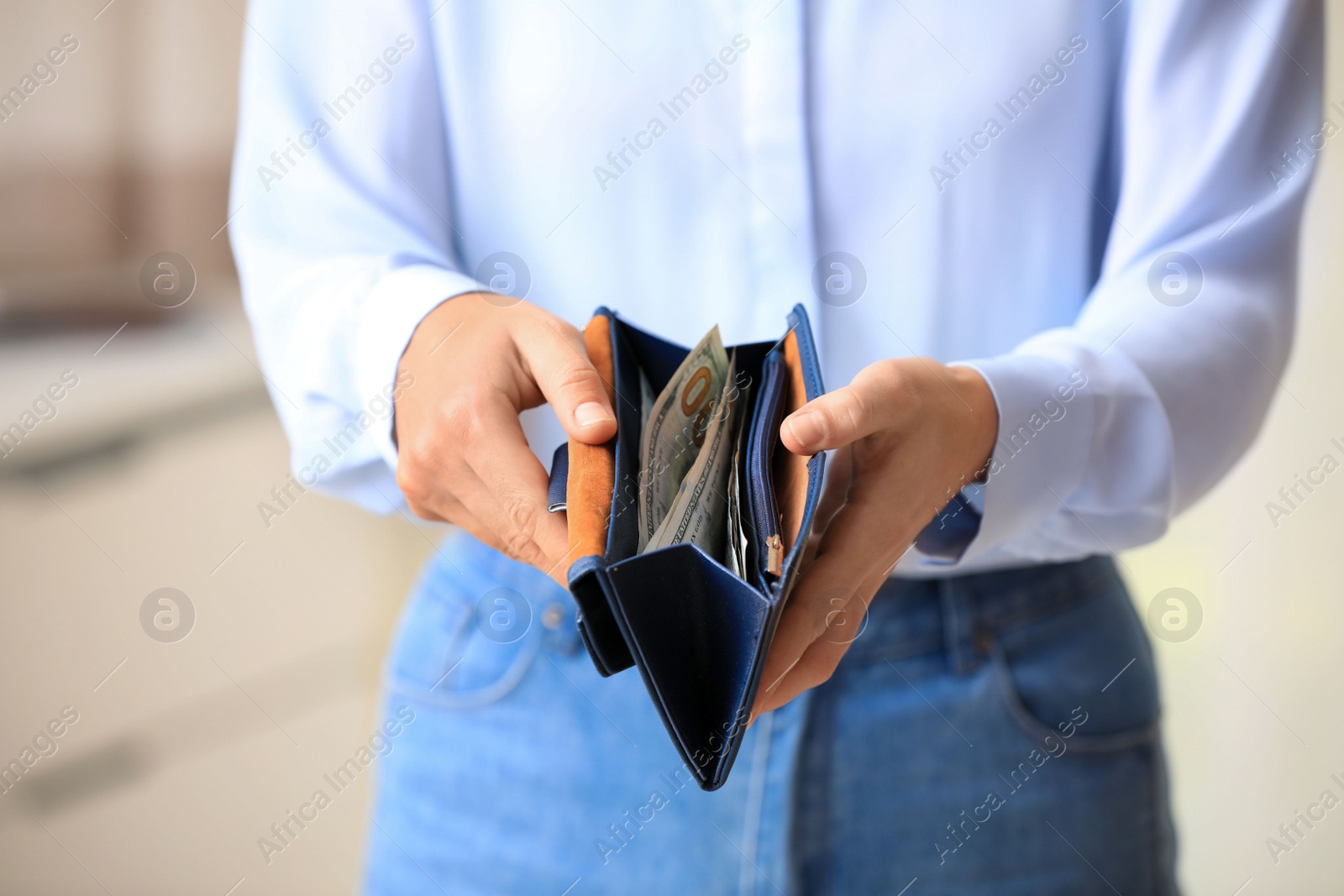 Photo of Woman with American money in wallet indoors, closeup
