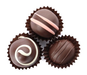 Many different delicious chocolate truffles on white background, top view