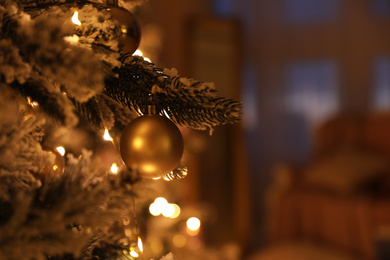 Photo of Closeup view of beautifully decorated Christmas tree indoors