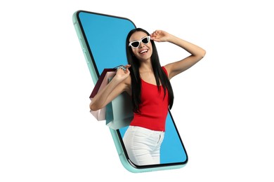 Image of Online shopping. Happy woman with paper bags looking out from smartphone on white background