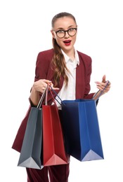Excited young businesswoman with shopping bags on white background