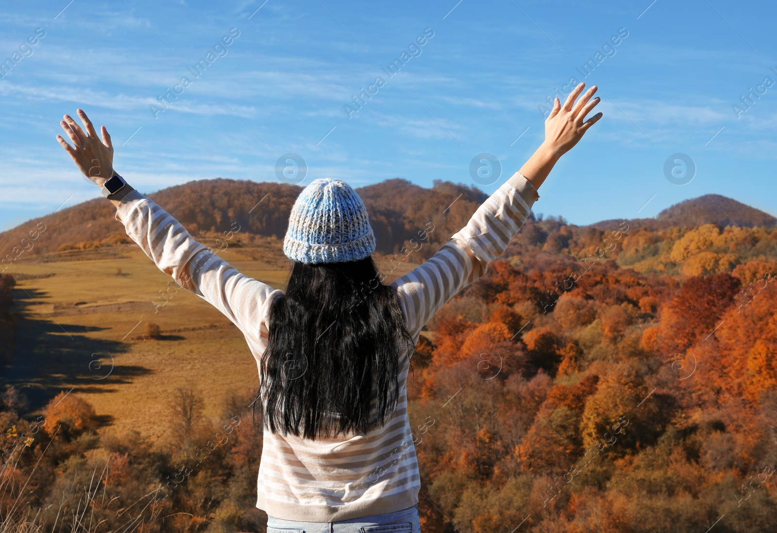 Photo of Female traveler feeling free in peaceful mountains