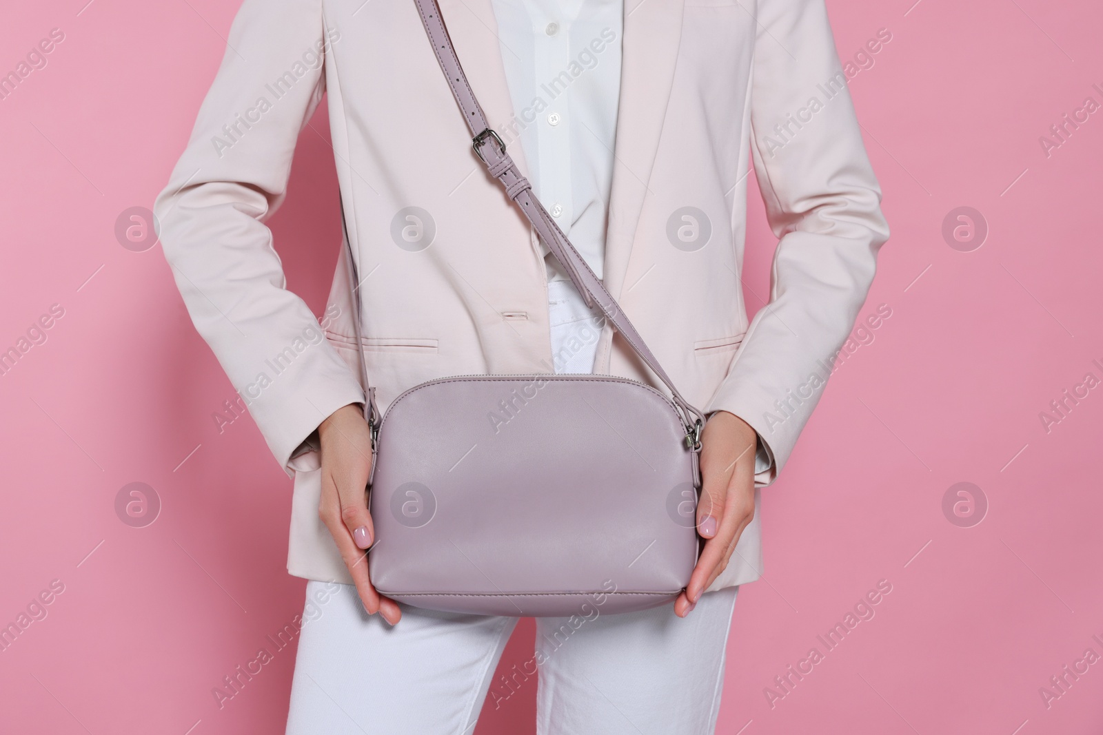 Photo of Woman with stylish bag on pink background, closeup