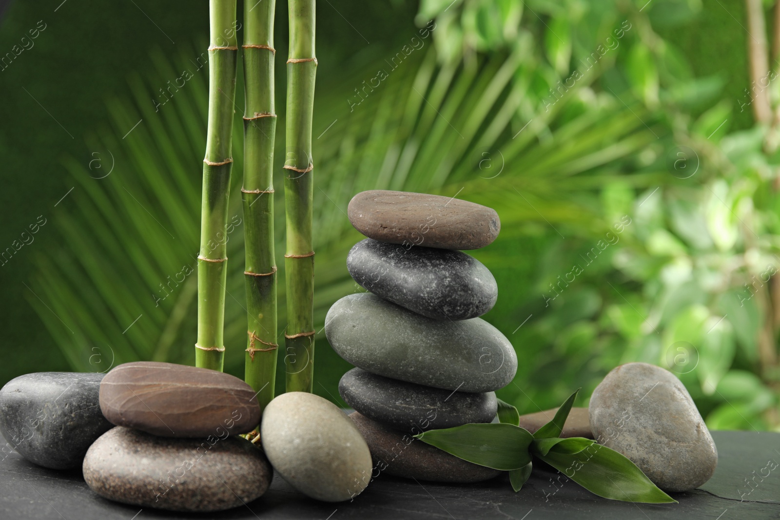 Photo of Composition with stones on table against blurred background. Zen concept