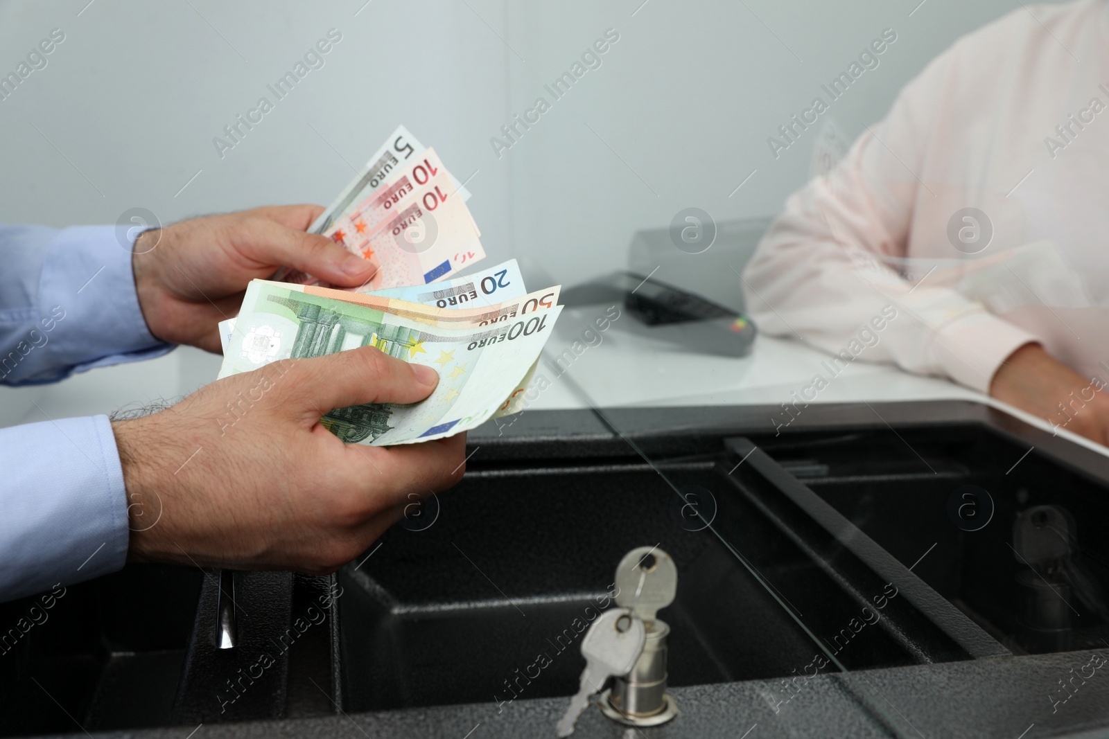 Photo of Cashier with money at cash department window, closeup. Currency exchange