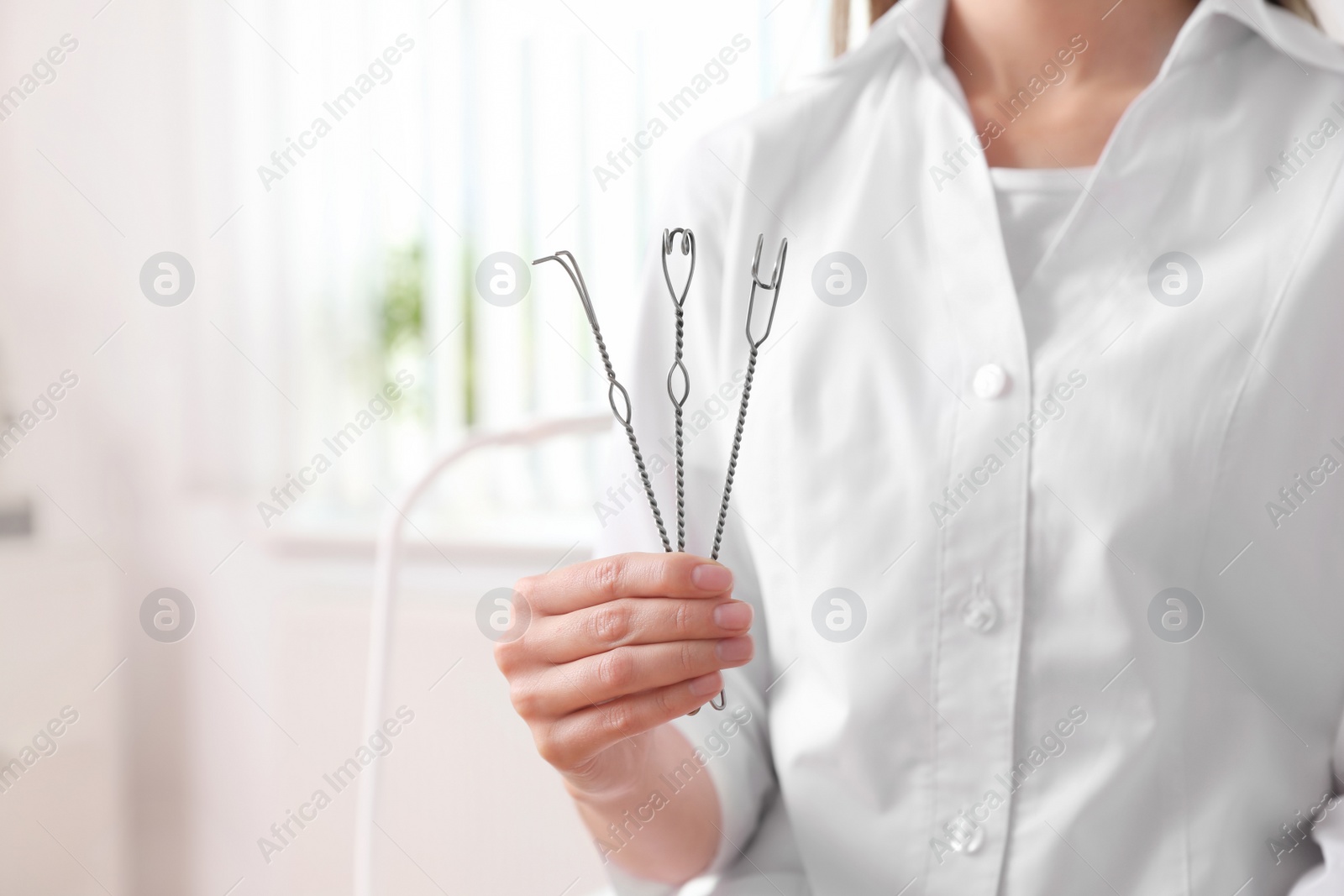 Photo of Speech therapist with logopedic probes in clinic, closeup. Space for text