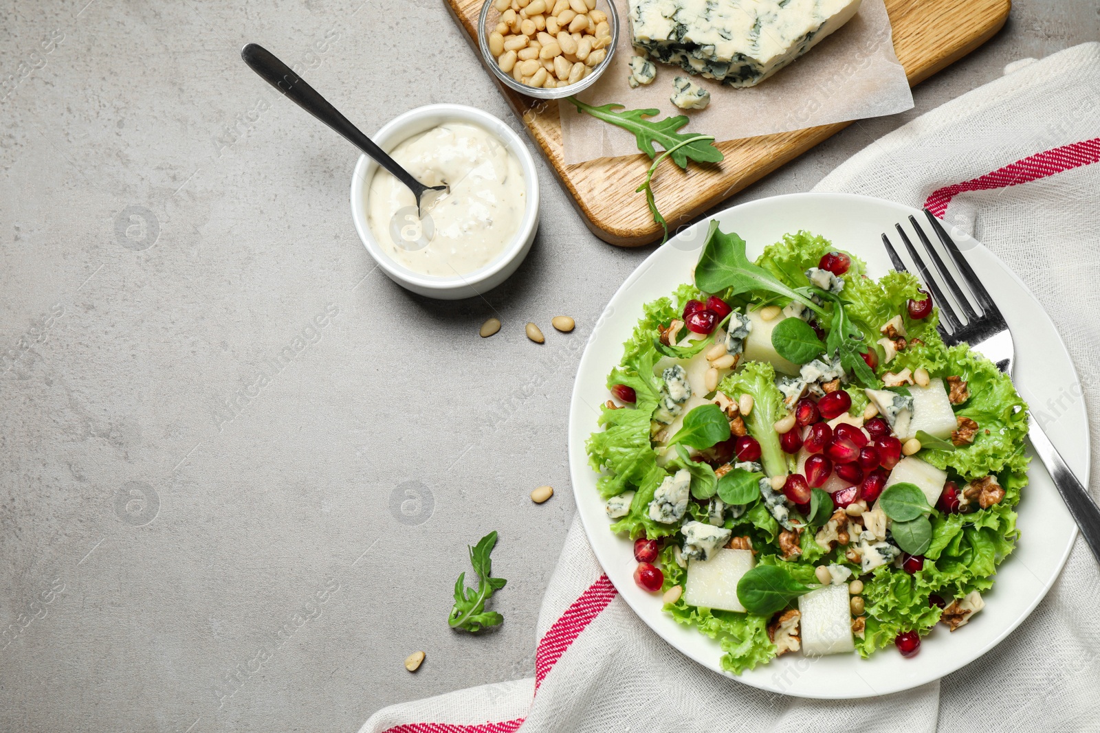 Photo of Fresh salad with pear served on grey table, flat lay. Space for text