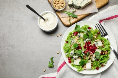 Fresh salad with pear served on grey table, flat lay. Space for text