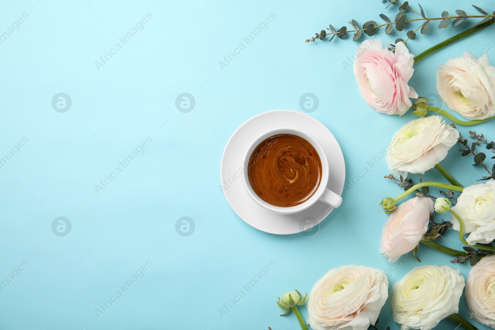 Photo of Flat lay composition with spring ranunculus flowers and cup of coffee on color background. Space for text