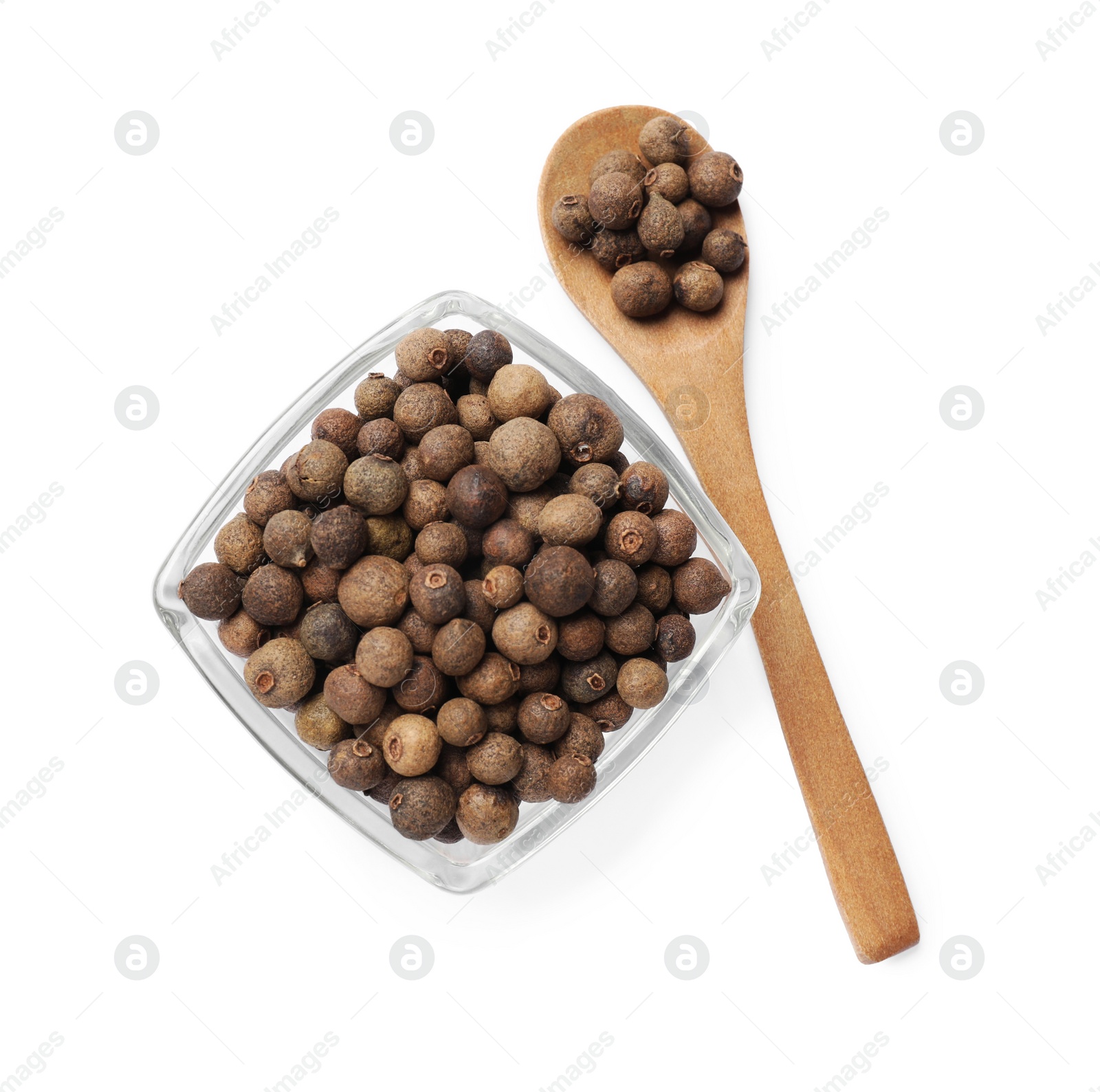 Photo of Dry allspice berries (Jamaica pepper) in bowl and spoon isolated on white, top view