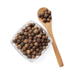 Dry allspice berries (Jamaica pepper) in bowl and spoon isolated on white, top view