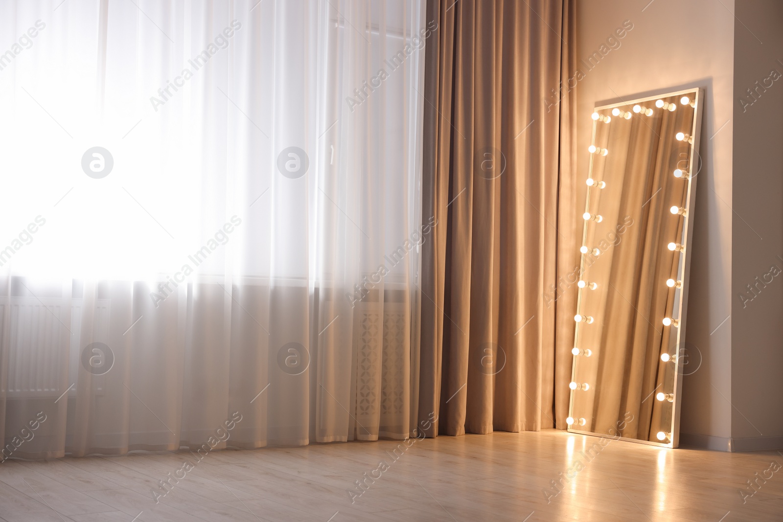 Photo of Modern mirror with light bulbs in makeup room