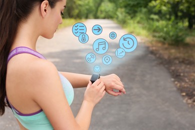 Young woman checking fitness tracker with smartwatch after training in park
