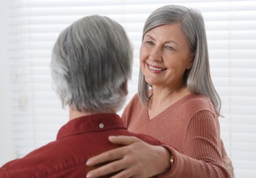 Photo of Happy senior couple spending time together at home