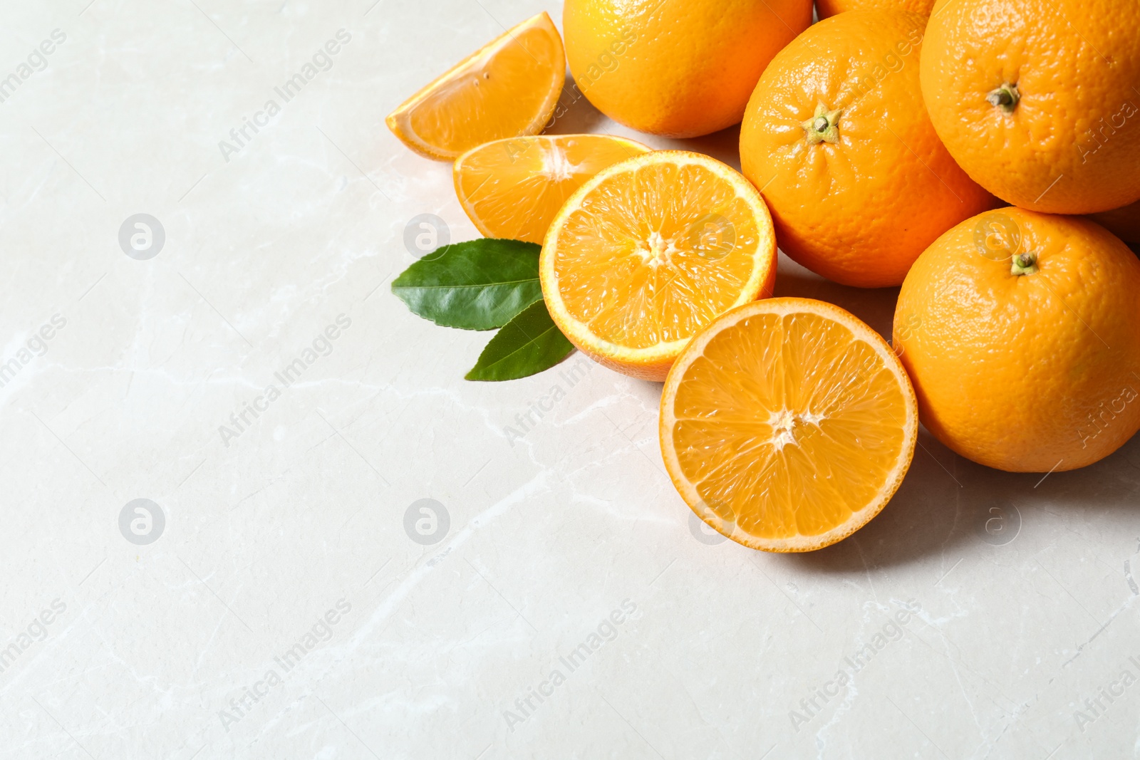 Photo of Fresh ripe oranges on light background. Space for text